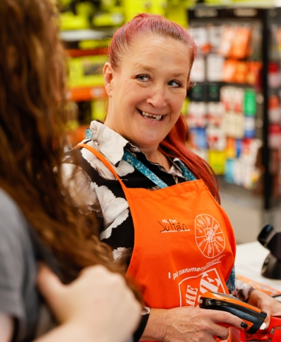 A Customer Experience Manager smiles at a customer.